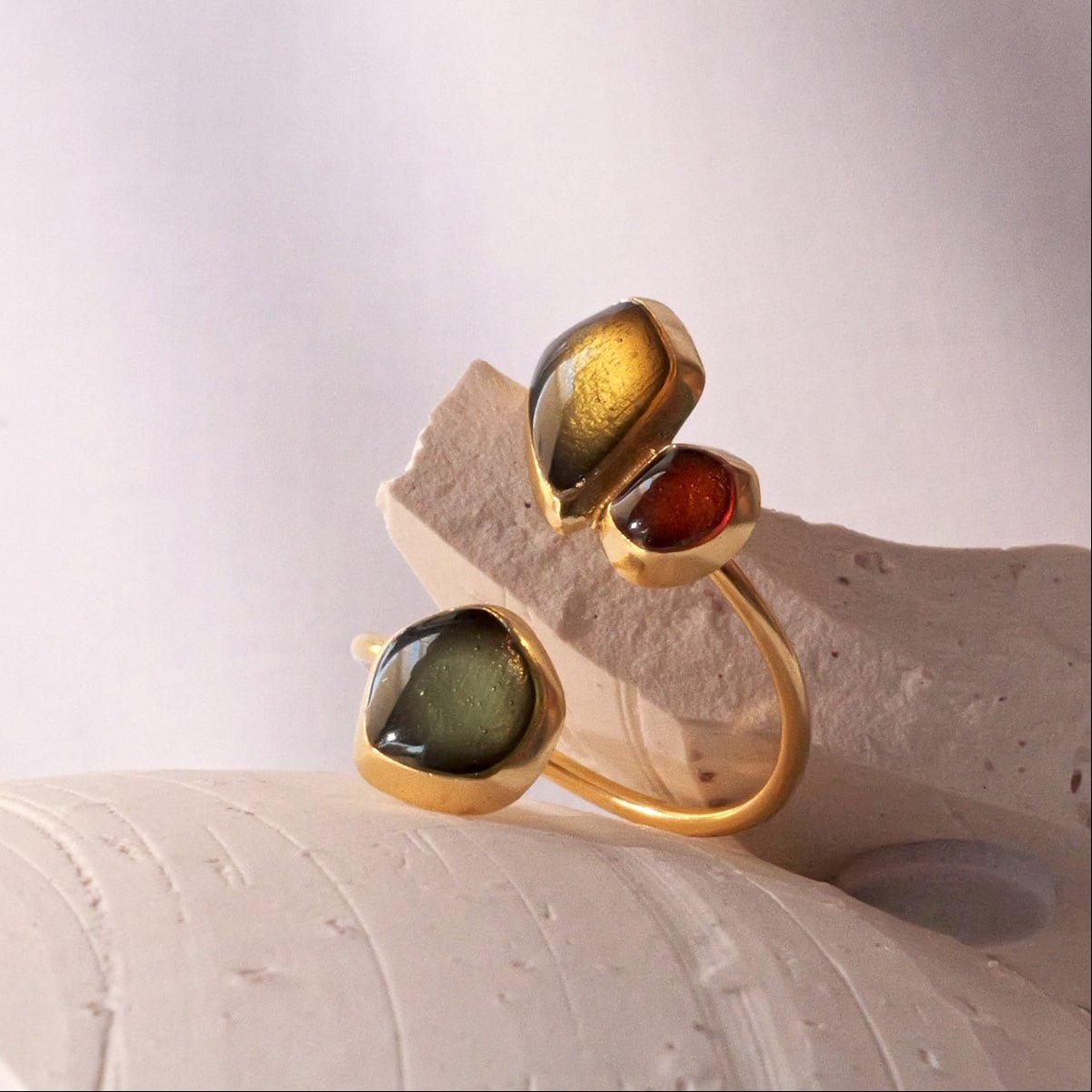 Gold=plated sterling silver ring with three irregular green  and red sea glass stones.